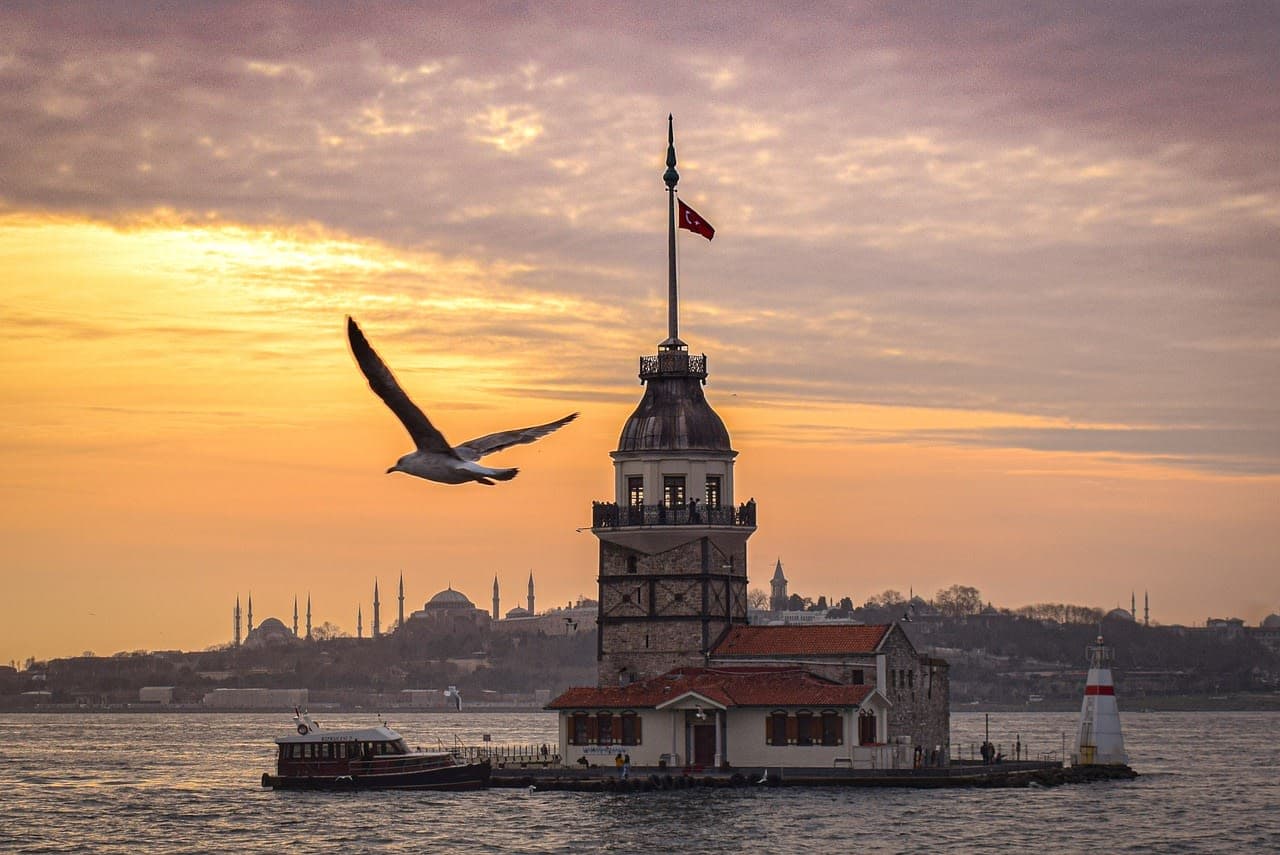 Maiden's Tower on the Bosphorus at sunset with Istanbul's skyline behind