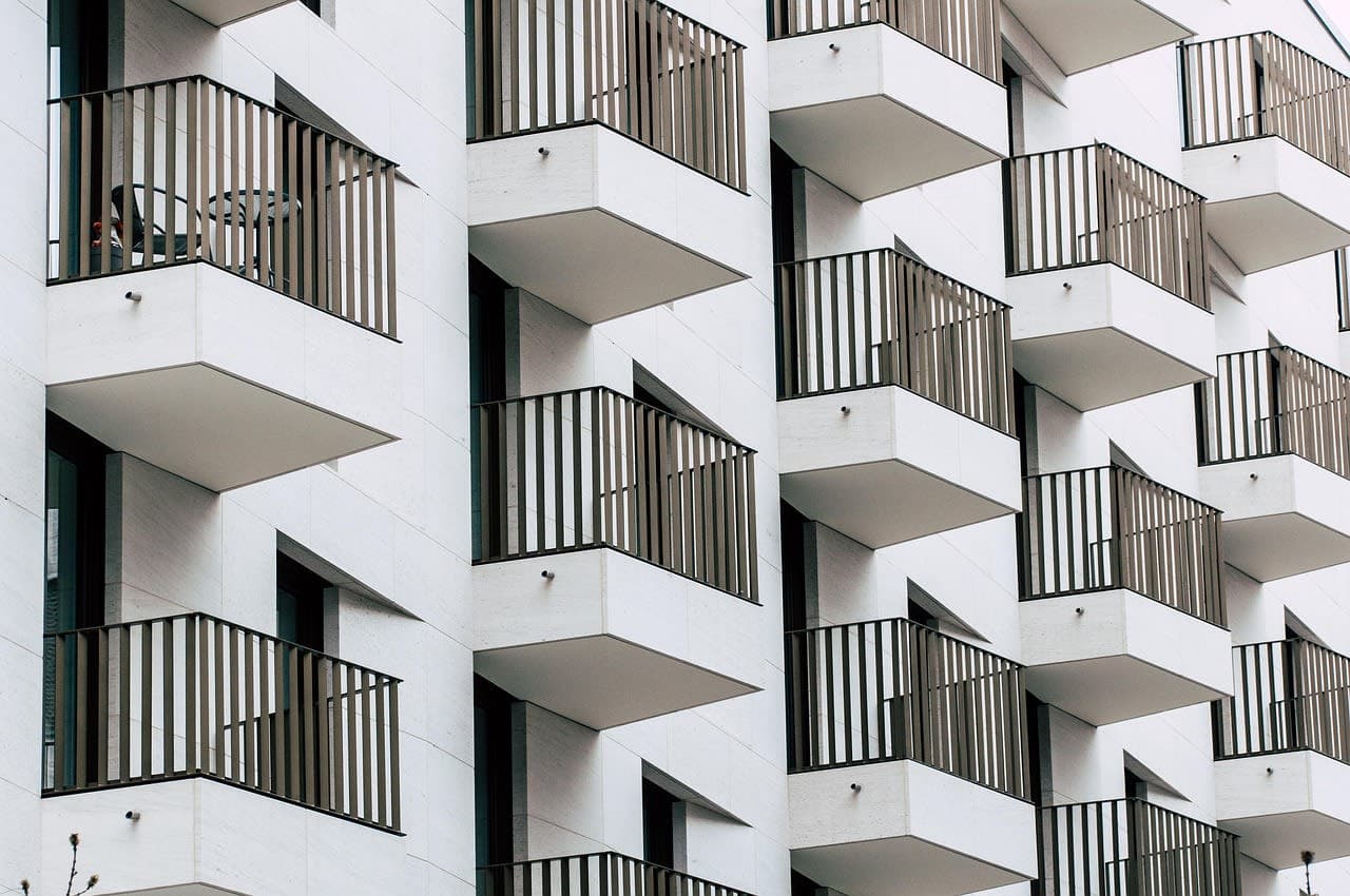 Modern apartment facade with rows of balconies