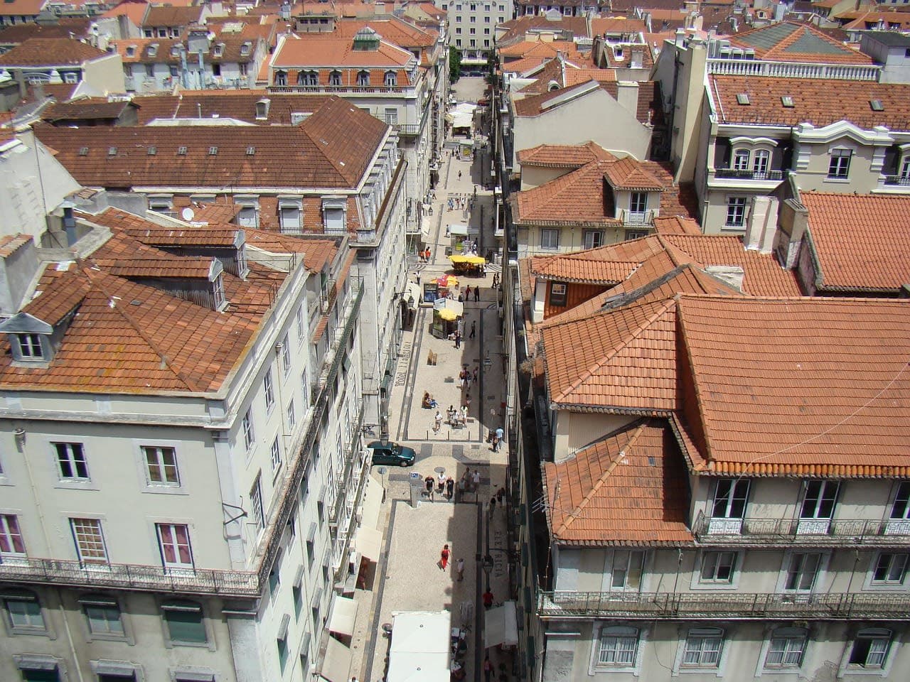 Terracotta rooftops and a narrow street in central Lisbon