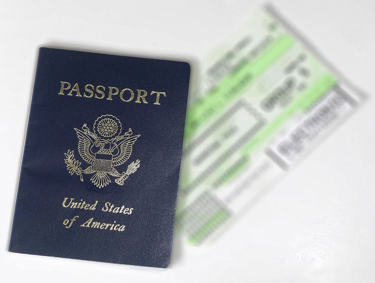 Passport beside a blurred boarding pass