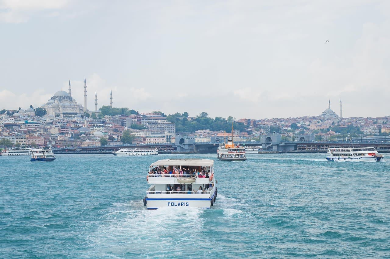 Ferries crossing the Bosphorus with the Istanbul skyline behind